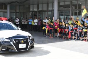 座喜味市長や子供たち、関係者が見守る中、パレードに出発する車両＝10日、市役所