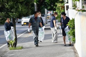 歩道に落ちたごみを拾い集める参加者ら＝20日、平良下里