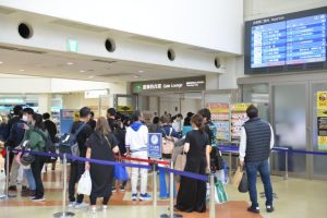 手荷物検査場前の時刻表を見る人たち＝３日、宮古空港