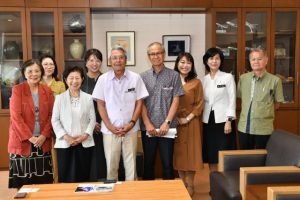 「金井喜久子物語」の開催を報告した鎌田さん（前列左から２人目）ら＝２２日、市役所